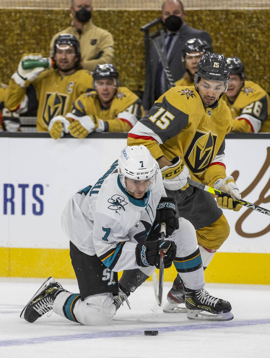 San Jose Sharks center Dylan Gambrell (7) drops to a knee to shoot the puck with Golden Knights ...