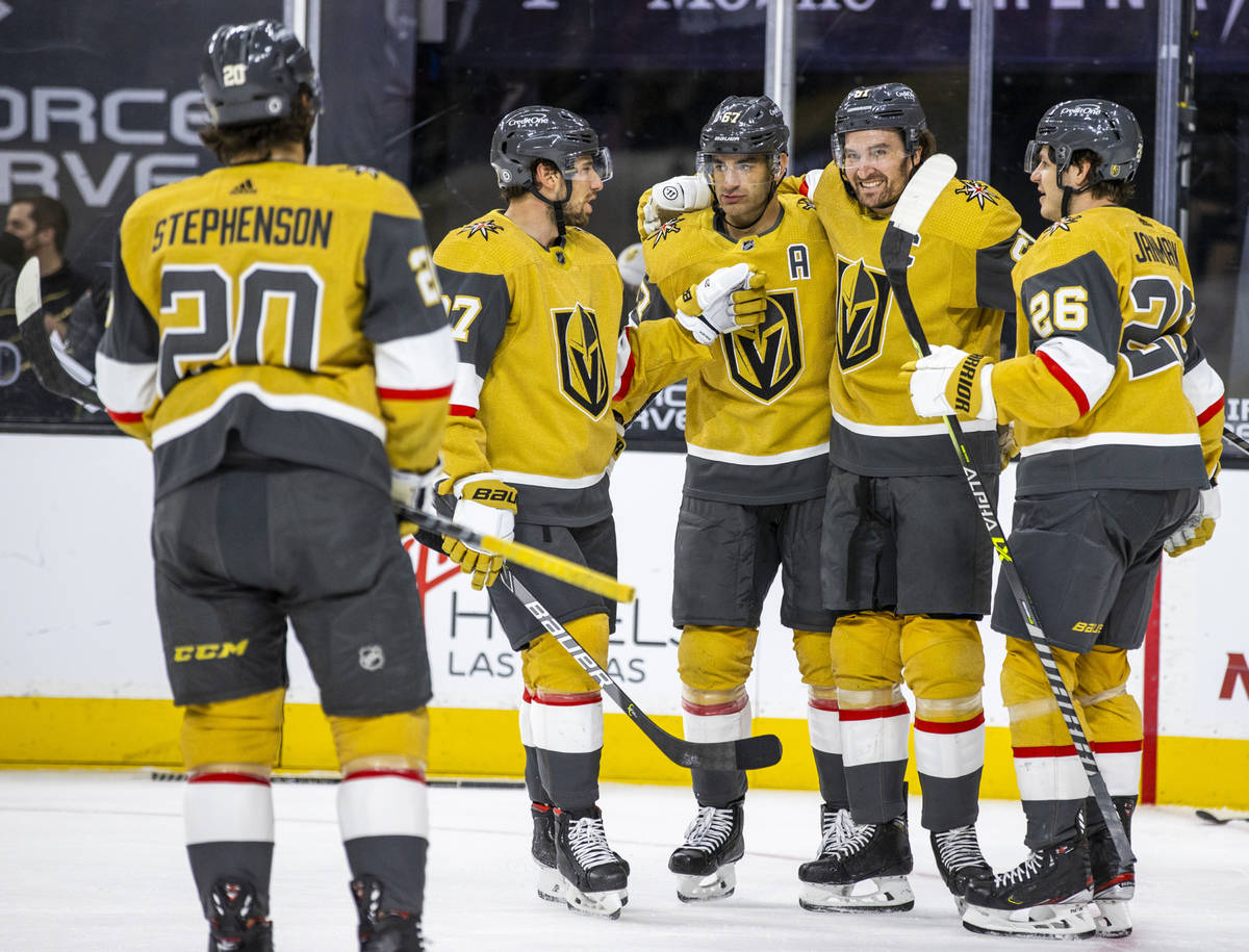 Golden Knights right wing Mark Stone (61) is congratulated by teammates after scoring on San Jo ...