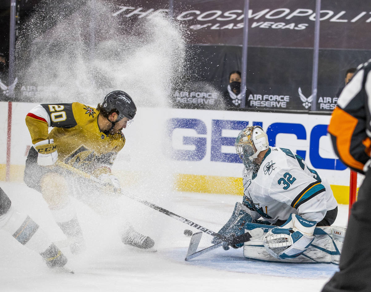 Golden Knights center Chandler Stephenson (20) kicks up some ice shaving as he attempts a shot ...