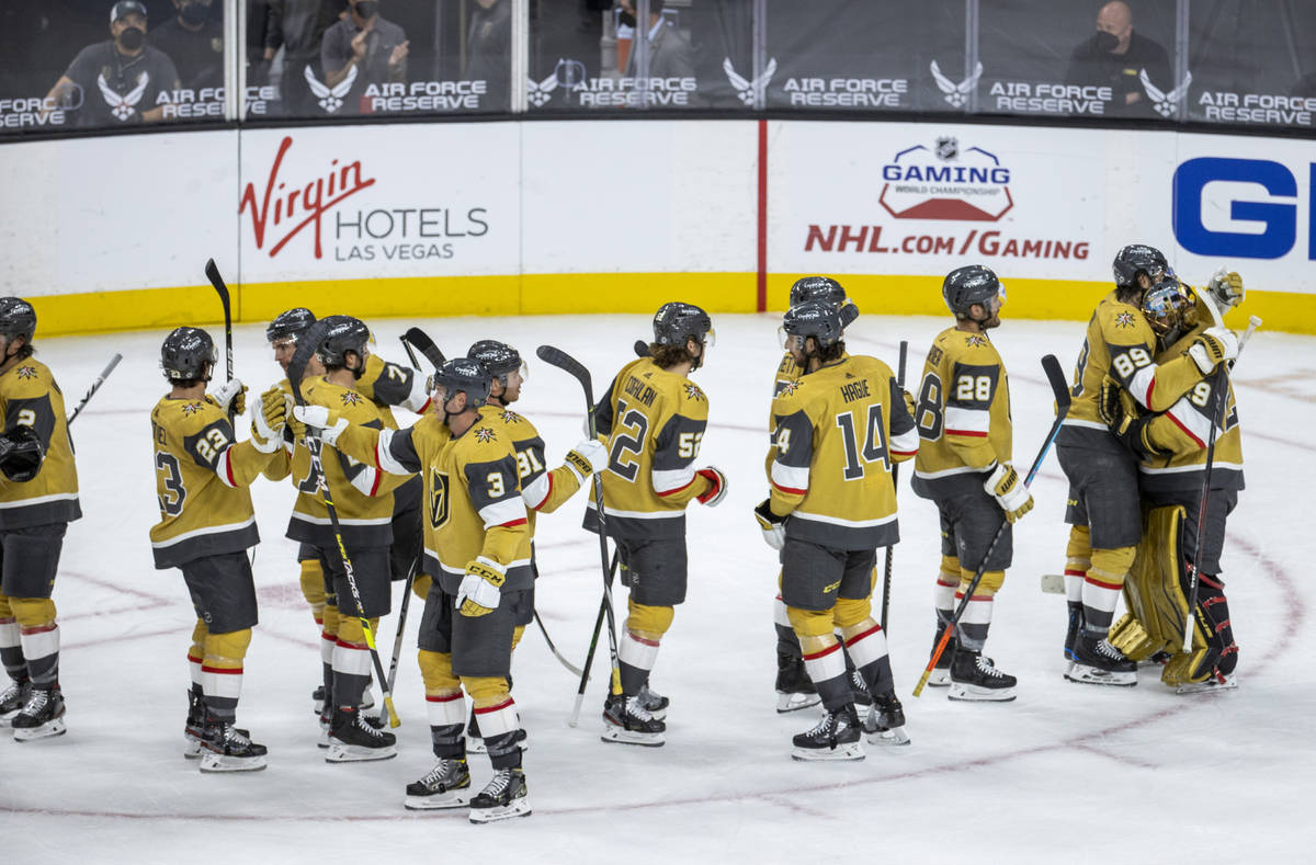 Golden Knights goaltender Marc-Andre Fleury (29, right) is congratulated by teammates on a 5-2 ...