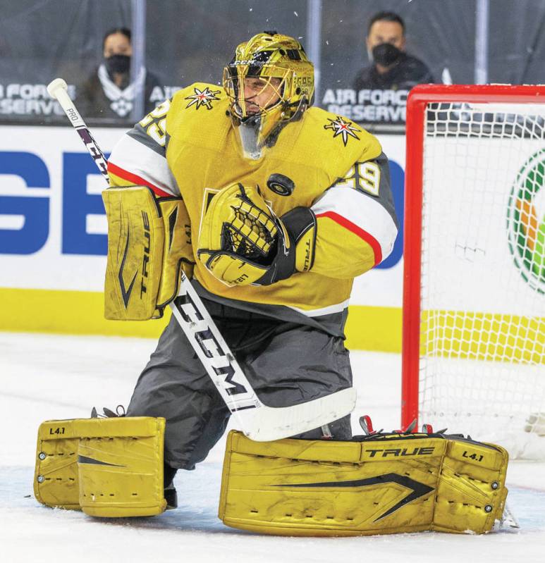 Golden Knights goaltender Marc-Andre Fleury (29) deflects a puck off his chest pad versus the S ...