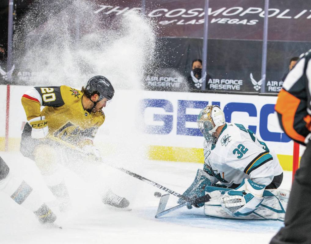 Golden Knights center Chandler Stephenson (20) kicks up some ice shaving as he attempts a shot ...