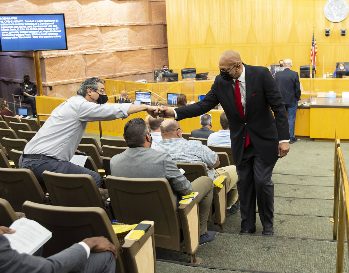 Former NBA player Jackie Robinson exchanges fist bumps with supporters inside commission chambe ...