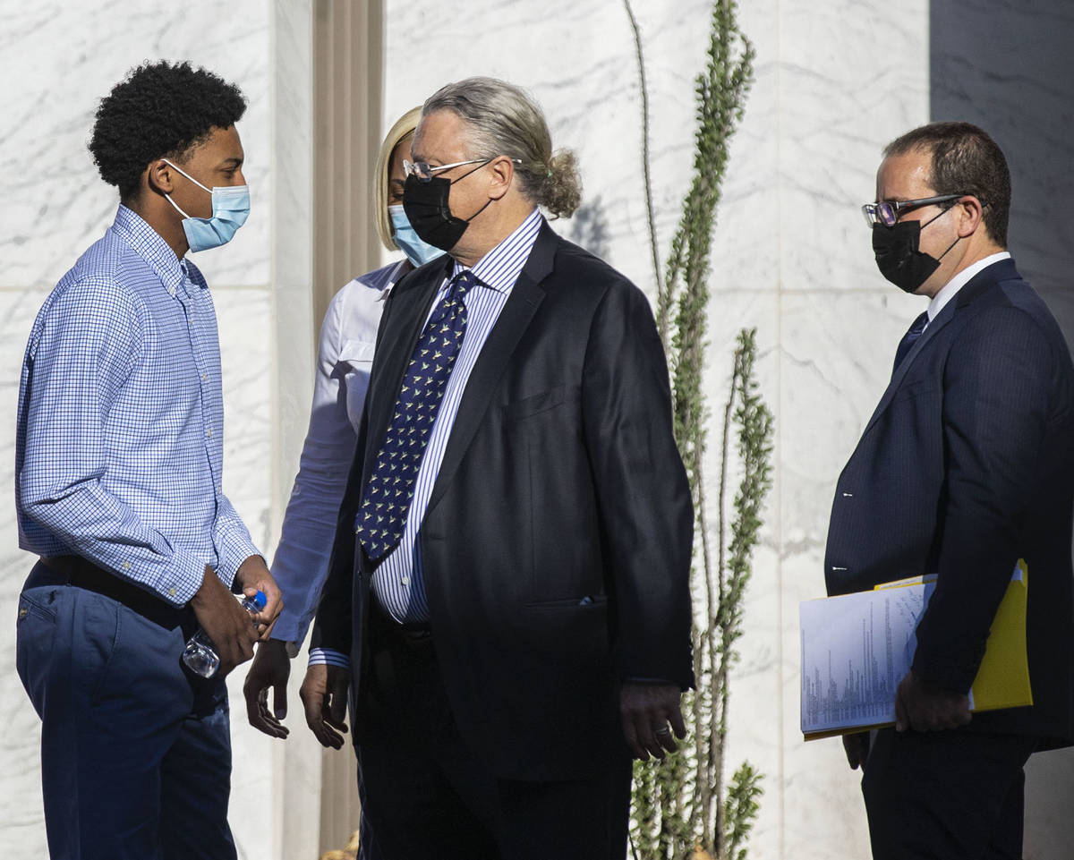 Former Bishop Gorman High School basketball standout Zaon Collins, second from left, talks with ...