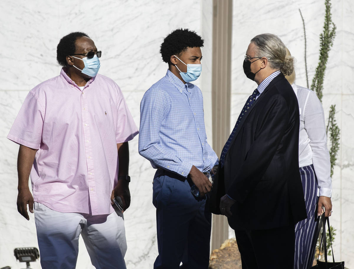 Former Bishop Gorman High School basketball standout Zaon Collins, second from left, talks with ...