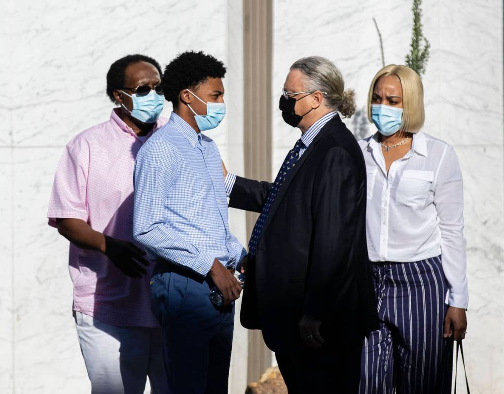Former Bishop Gorman High School basketball standout Zaon Collins, second from left, talks with ...