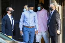 Former Bishop Gorman High School basketball standout Zaon Collins, center, leaves his attorneys ...