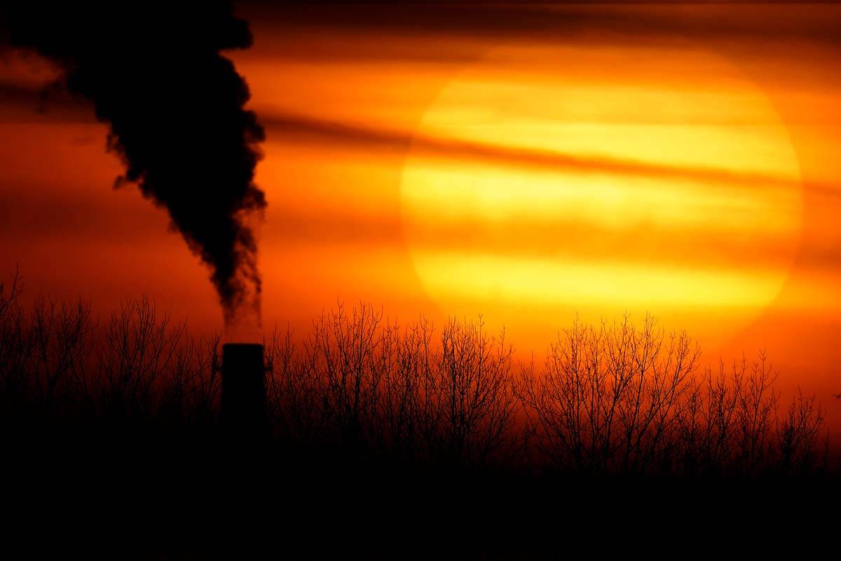 In this Feb. 1, 2021 file photo, emissions from a coal-fired power plant are silhouetted agains ...