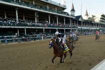 Jockey John Velazquez riding Authentic, wins the 146th running of the Kentucky Derby at Churchi ...
