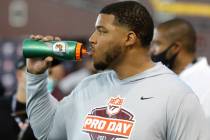 Christian Darrisaw lineman pauses for a drink during Virginia Tech pro day in Blacksburg, Va., ...