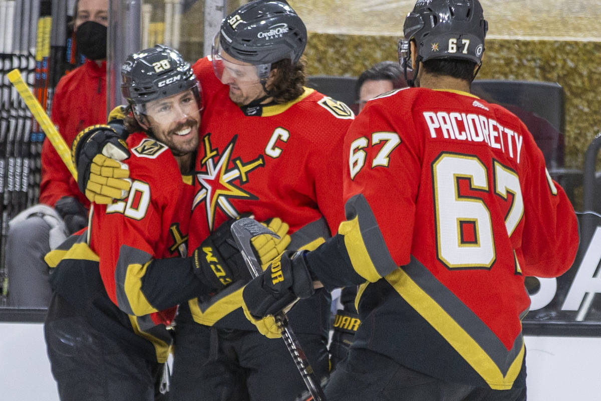 Golden Knights center Chandler Stephenson (20) is congratulated on a score by right wing Mark S ...