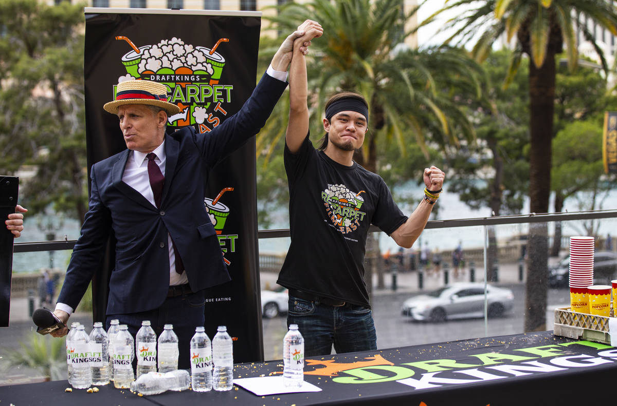 Announcer George Shea, left, declares Matt Stonie as the World Popcorn Eating Champion in the & ...