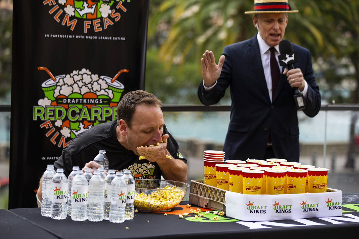 Competitive eating world champion Joey Chestnut competes as George Shea, right, emcees during t ...