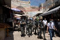 Israeli Border Police patrol the Old City of Jerusalem as worshippers arrive for Friday prayers ...