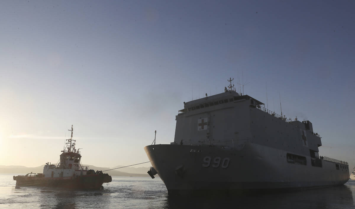 Indonesia navy hospital ship KRI Dr. Soeharso, right, sails to join the search for submarine KR ...