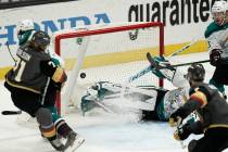 Vegas Golden Knights' William Karlsson, left, of Sweden, watches the puck enter the net for a g ...