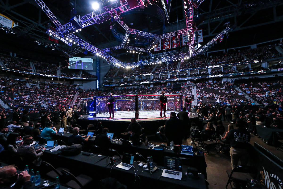 Fans await the next fight during a UFC 261 mixed martial arts event, Saturday, April 24, 2021, ...