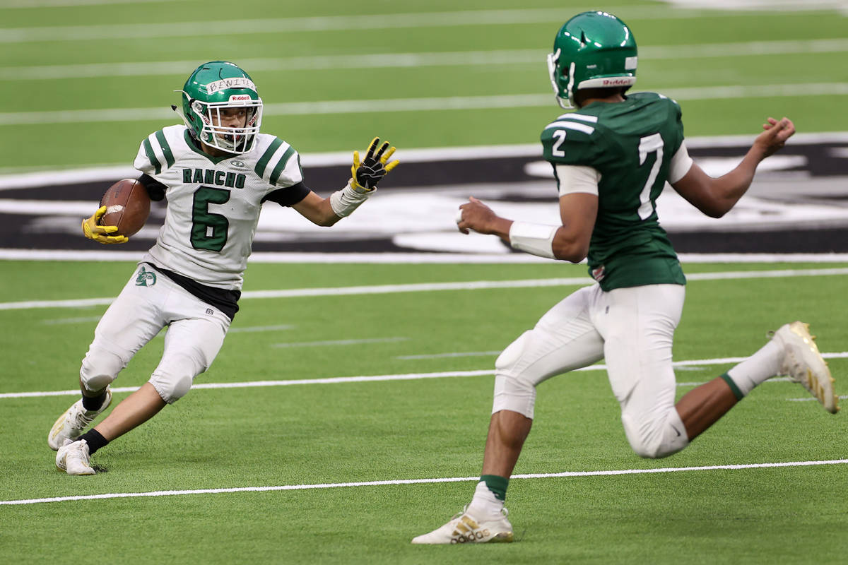 Rancho's Giovanni Benitez (6) runs the ball under pressure from Raymond Conner (2) during a tea ...