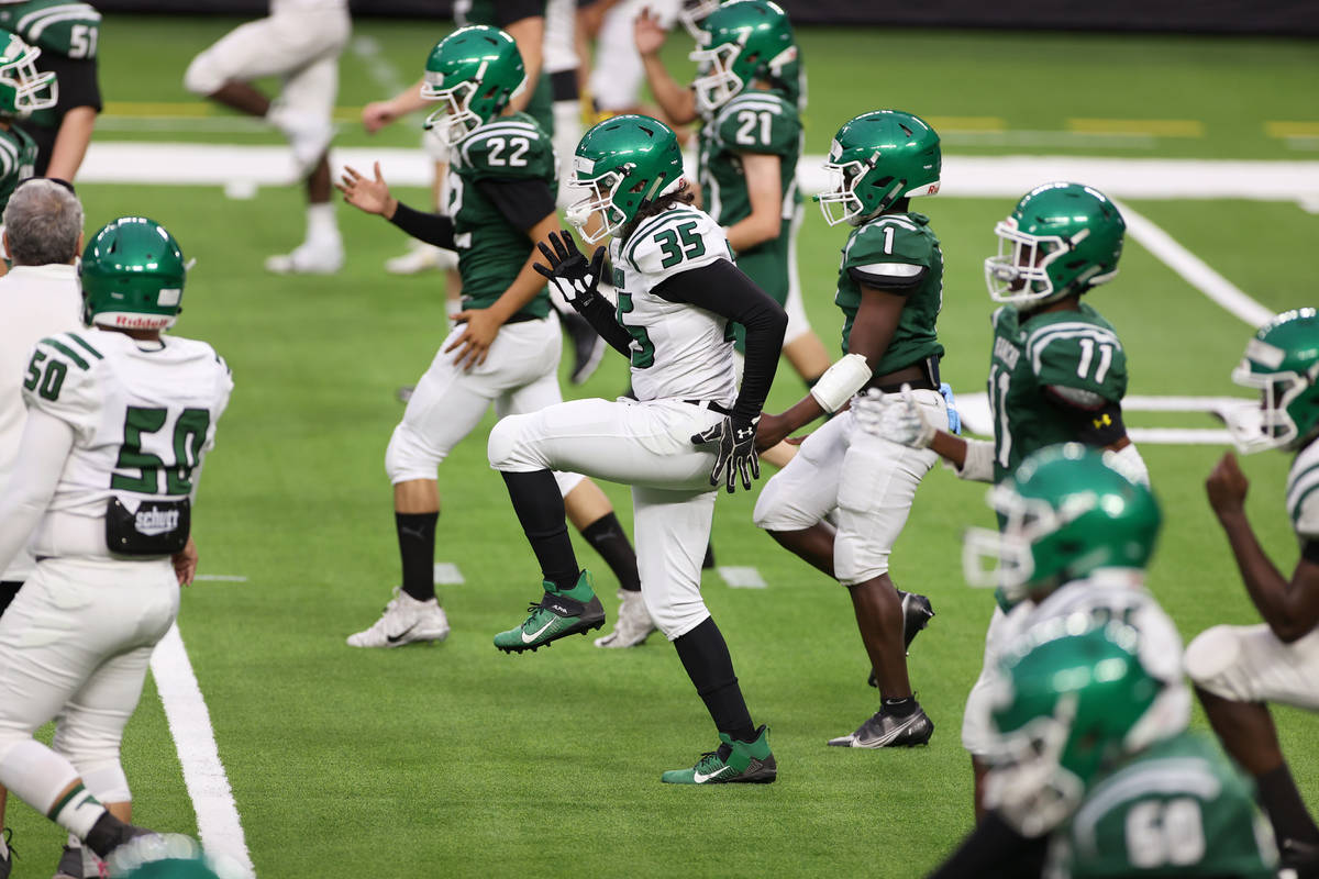 Rancho player stretch during a team football practice at Allegiant Stadium in Las Vegas, Saturd ...