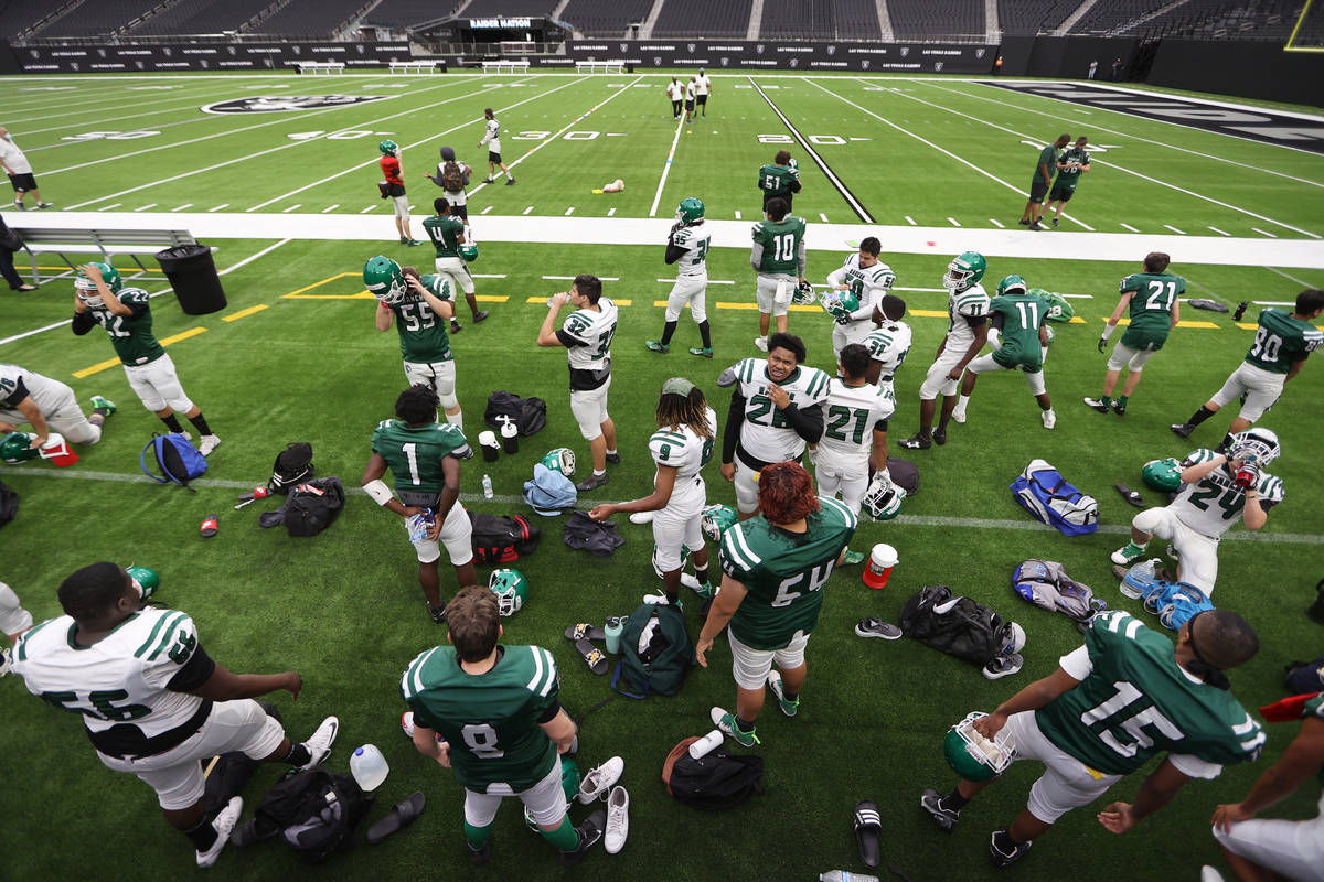Rancho players take a water break during a team football practice at Allegiant Stadium in Las V ...