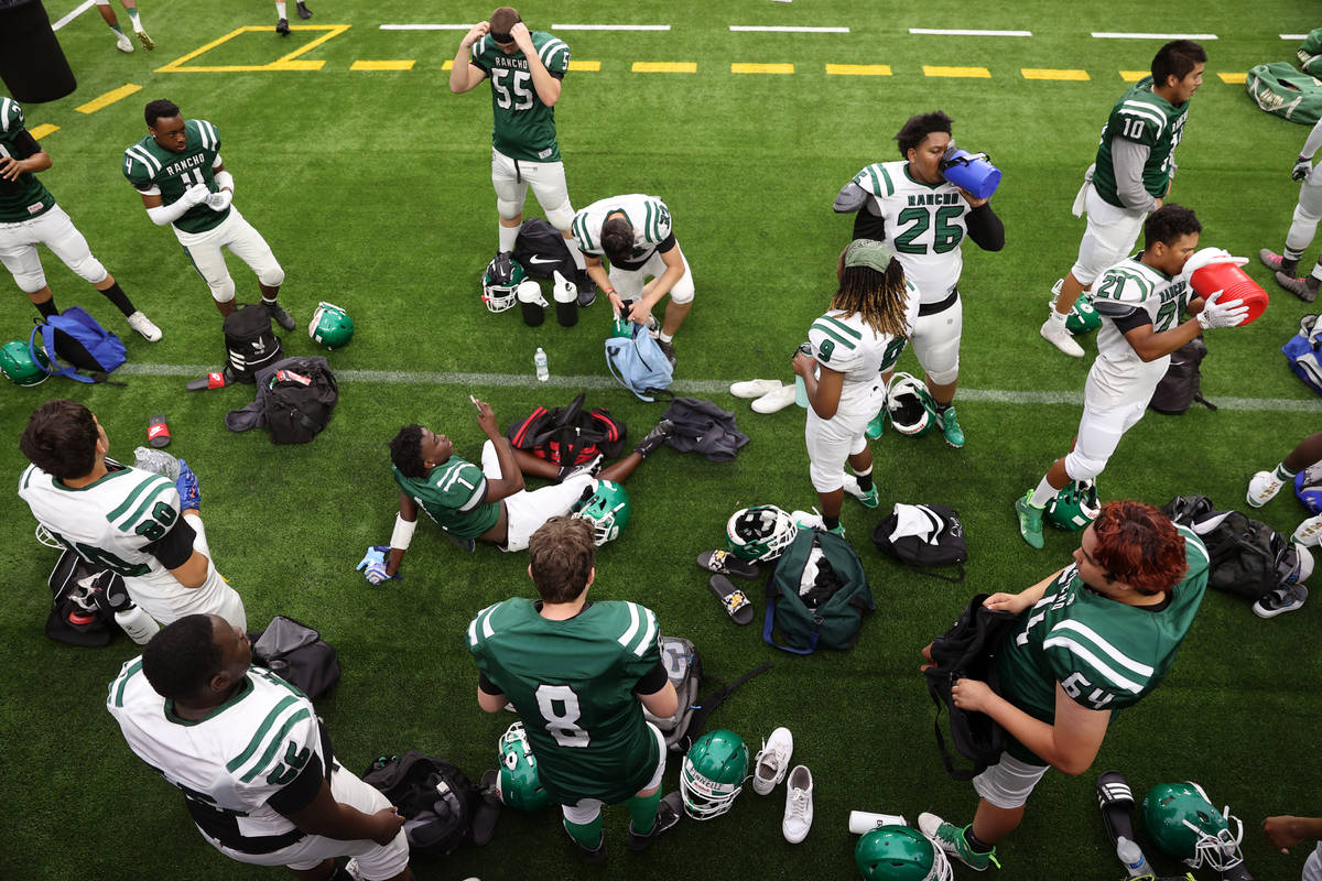 Rancho players take a water break during a team football practice at Allegiant Stadium in Las V ...