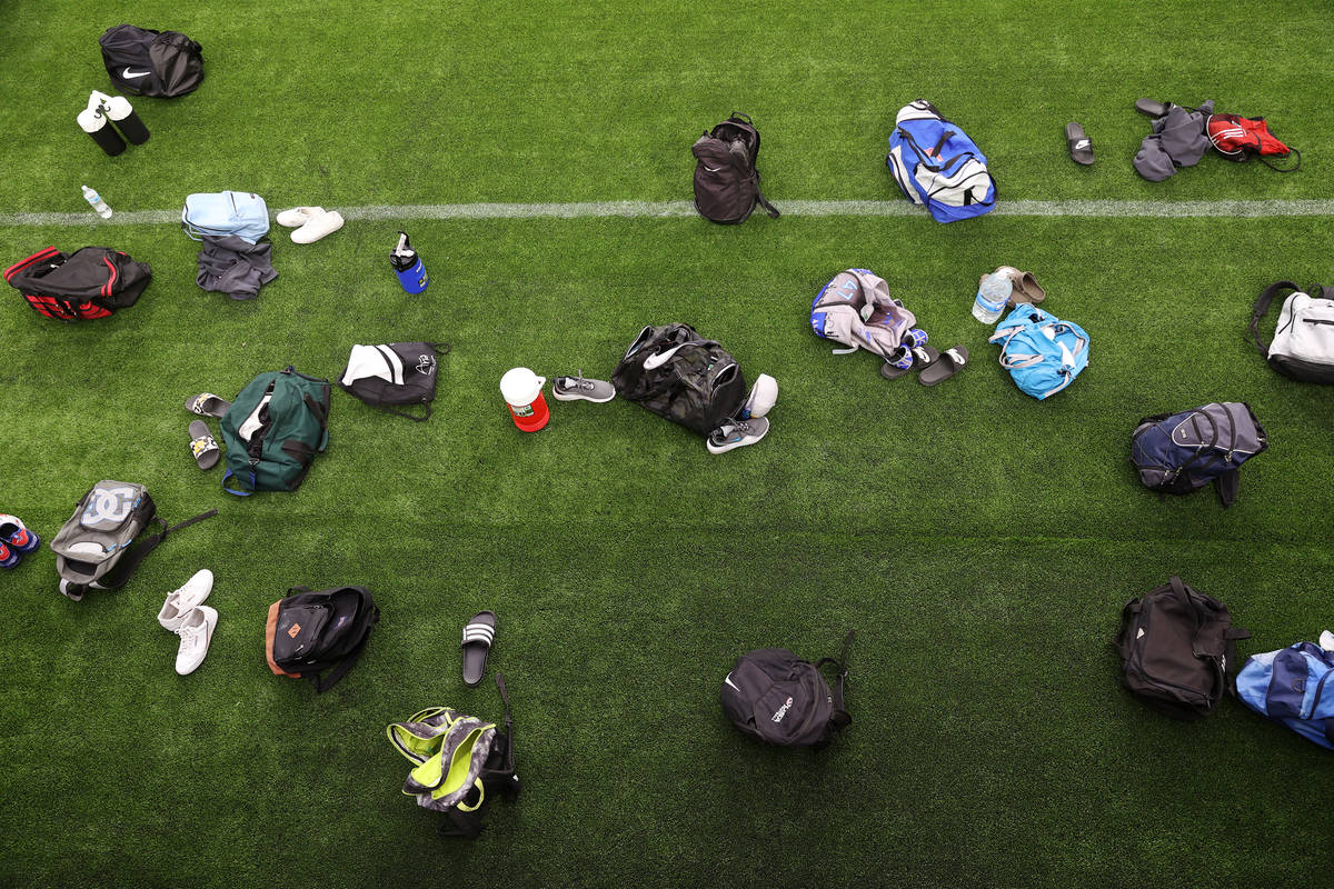 Rancho players belonging sit on the sideline during a team football practice at Allegiant Stadi ...