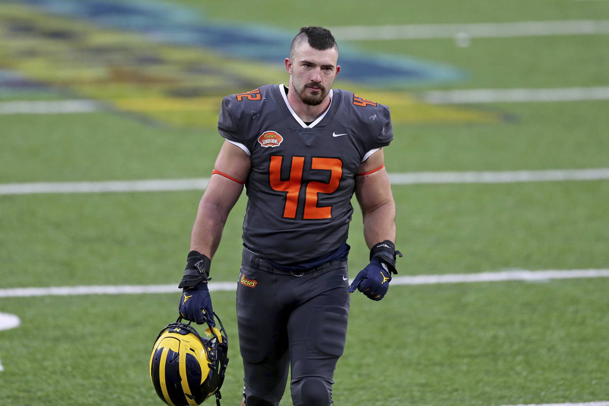 National Team fullback Ben Mason of Michigan (42) walk off the field after the NCAA college foo ...