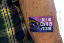 Dennis Hines sports a COVID-19 vaccine sticker as Immunize Nevada partners with Asian Community ...