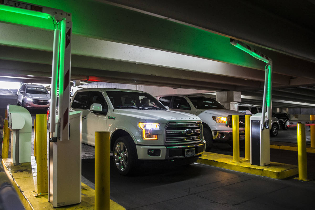 Guests pay for parking at the Caesars Palace garage on Thursday, May 16, 2019, in Las Vegas. (L ...