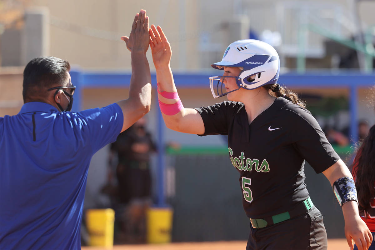 Green Valley's Ava Mearideth (5) high fives coach Tony Perez after a single in the third inning ...