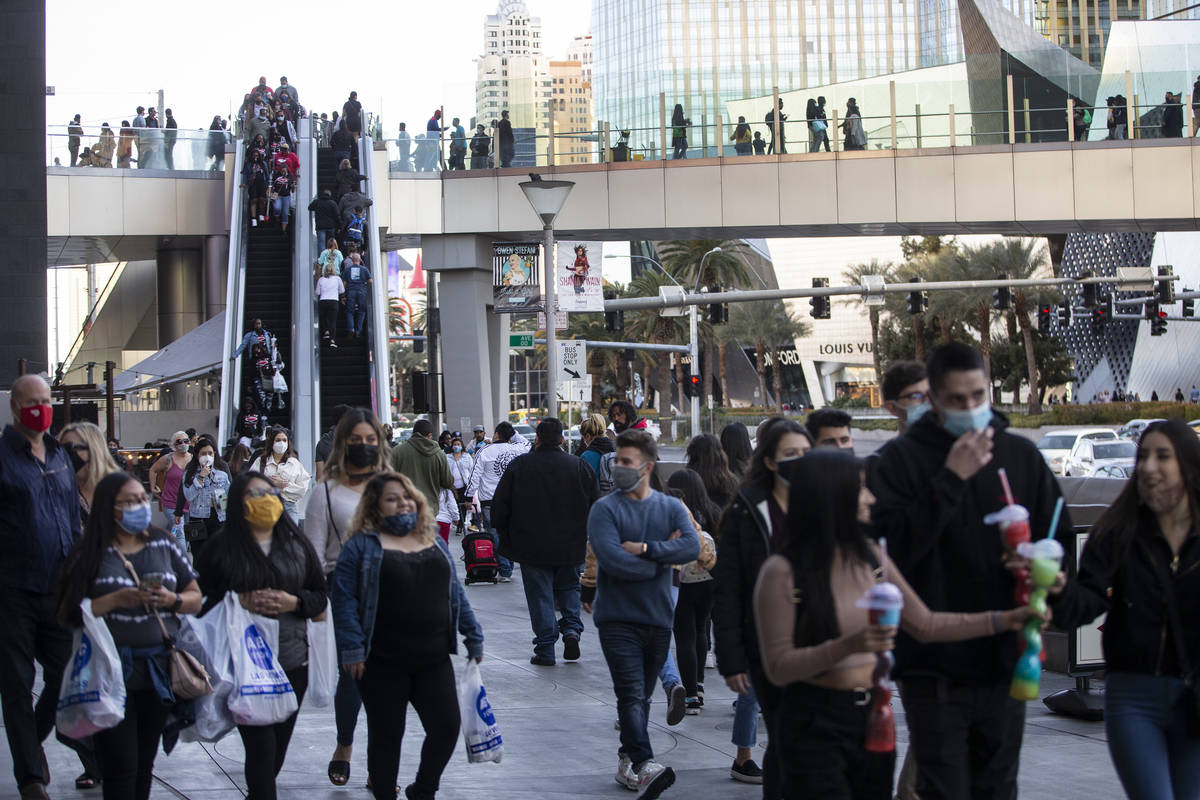 People visit the Strip near the Planet Hollywood hotel-casino in Las Vegas, on Saturday, March ...