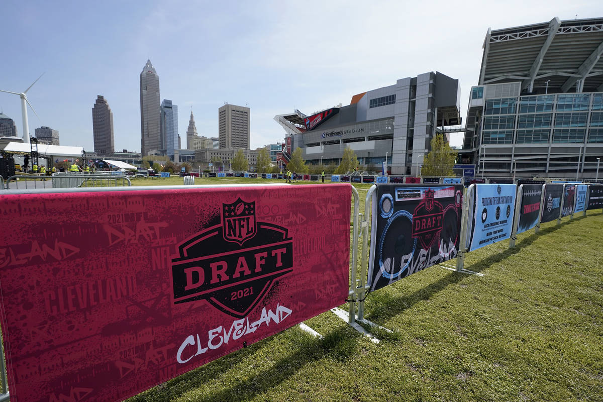 NFL Draft signs decorate the fan experience area near First Energy Stadium, Tuesday, April 27, ...