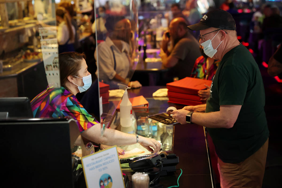 Cashier Jessica Rodosh, left, assists a customer at Peppermill in Las Vegas, Thursday, April 29 ...