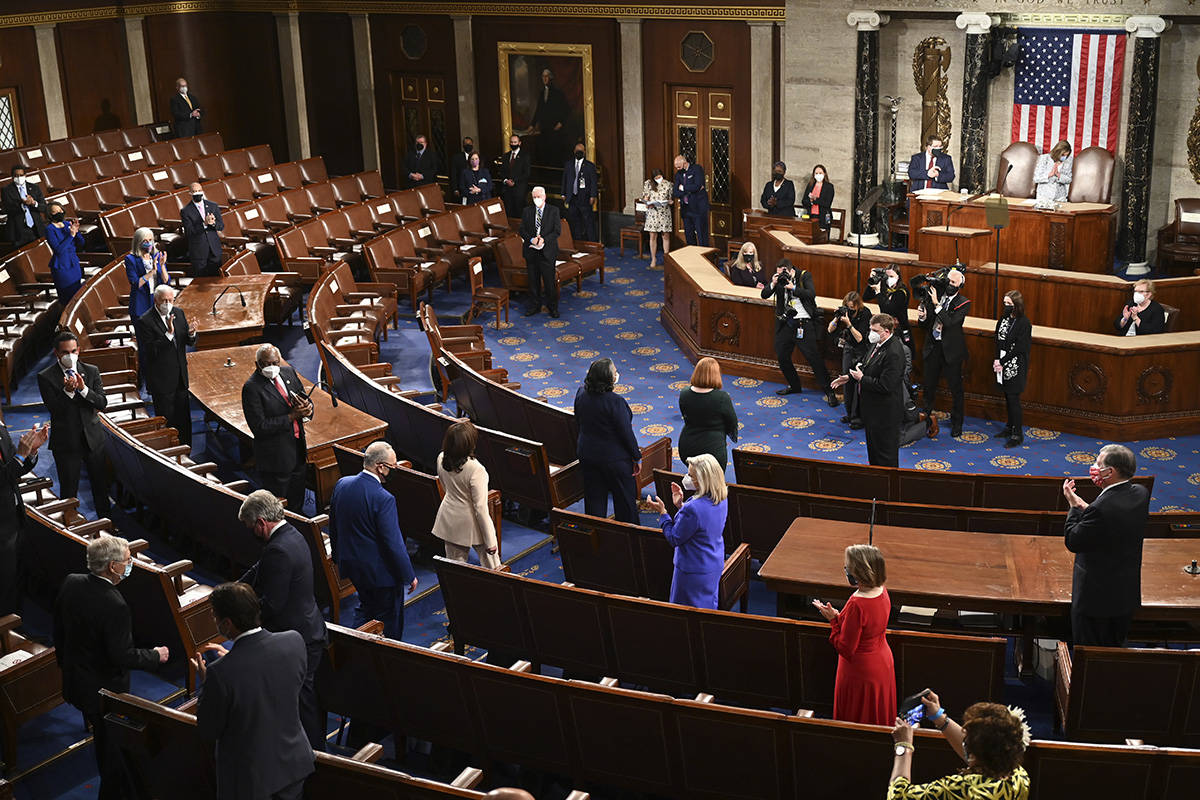 Members of Congress applaud as Vice President Kamala Harris, center, arrives before President J ...