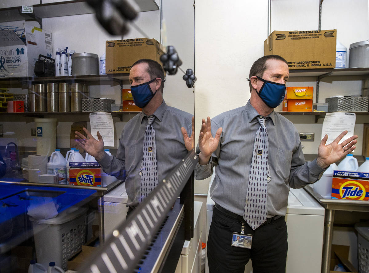 Dr. Mark Pandori, director of the Nevada State Public Health Lab, with one of their automated g ...