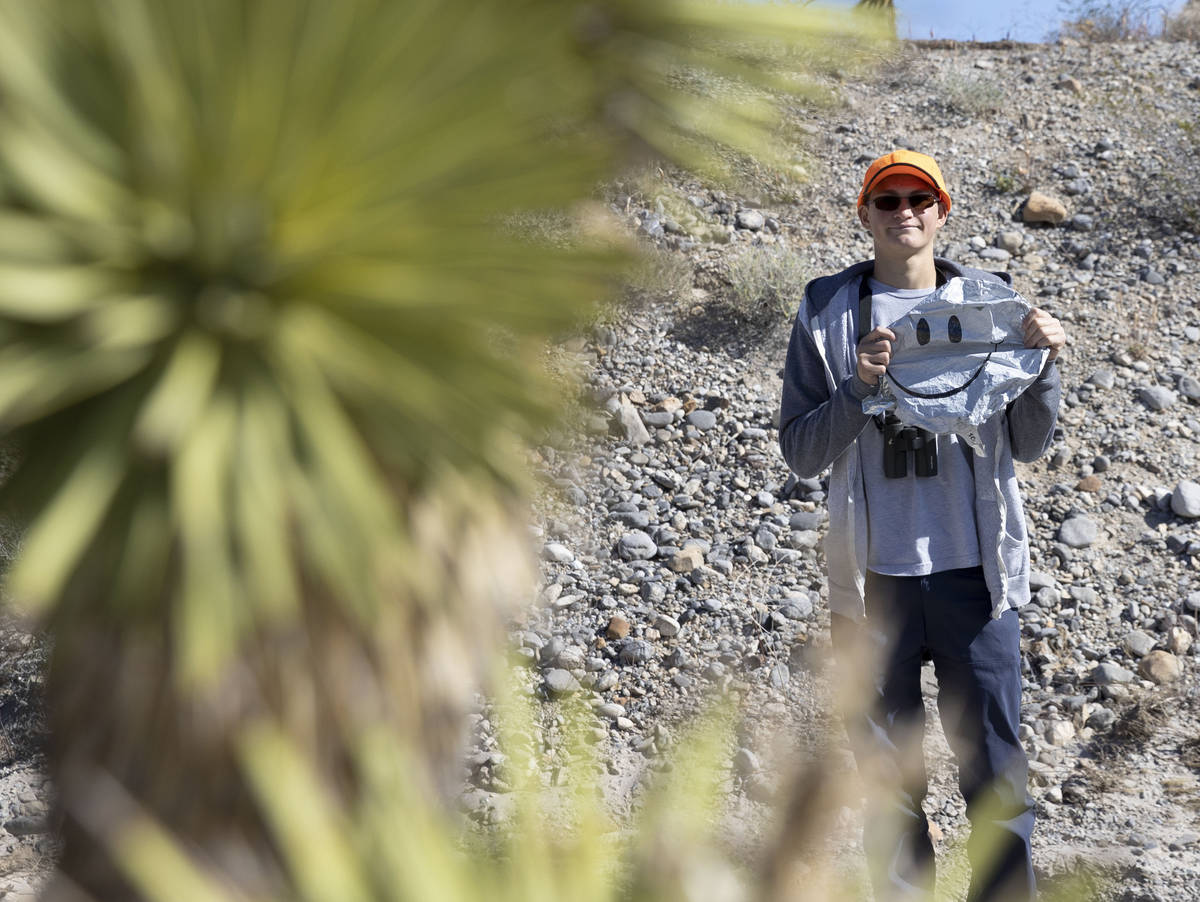 Christian Daniels, 15, displays a smiley face balloon he retrieved from the desert on Saturday, ...