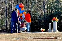 FILE - In this Feb. 23, 2021, file photo, Wanda Cooper-Jones kneels before the grave of her son ...