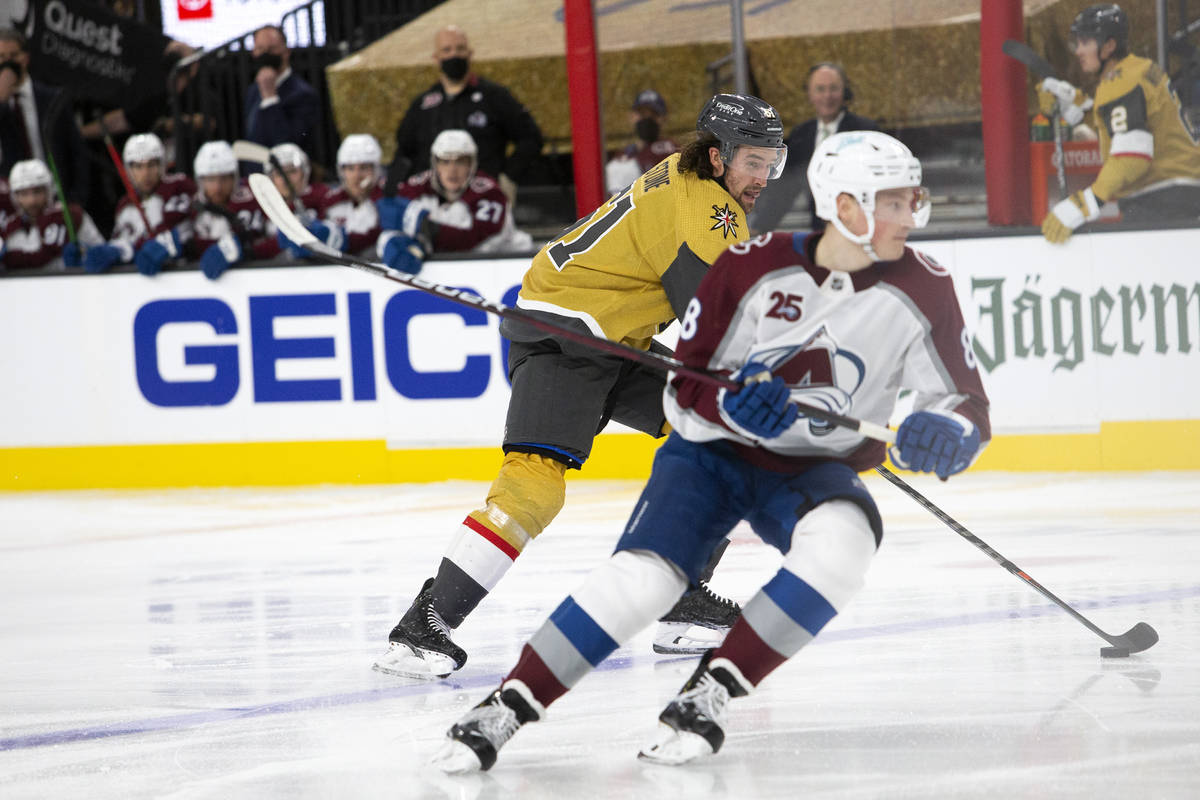 Golden Knights right wing Mark Stone (61) skates toward the net flanked by Avalanche defenseman ...