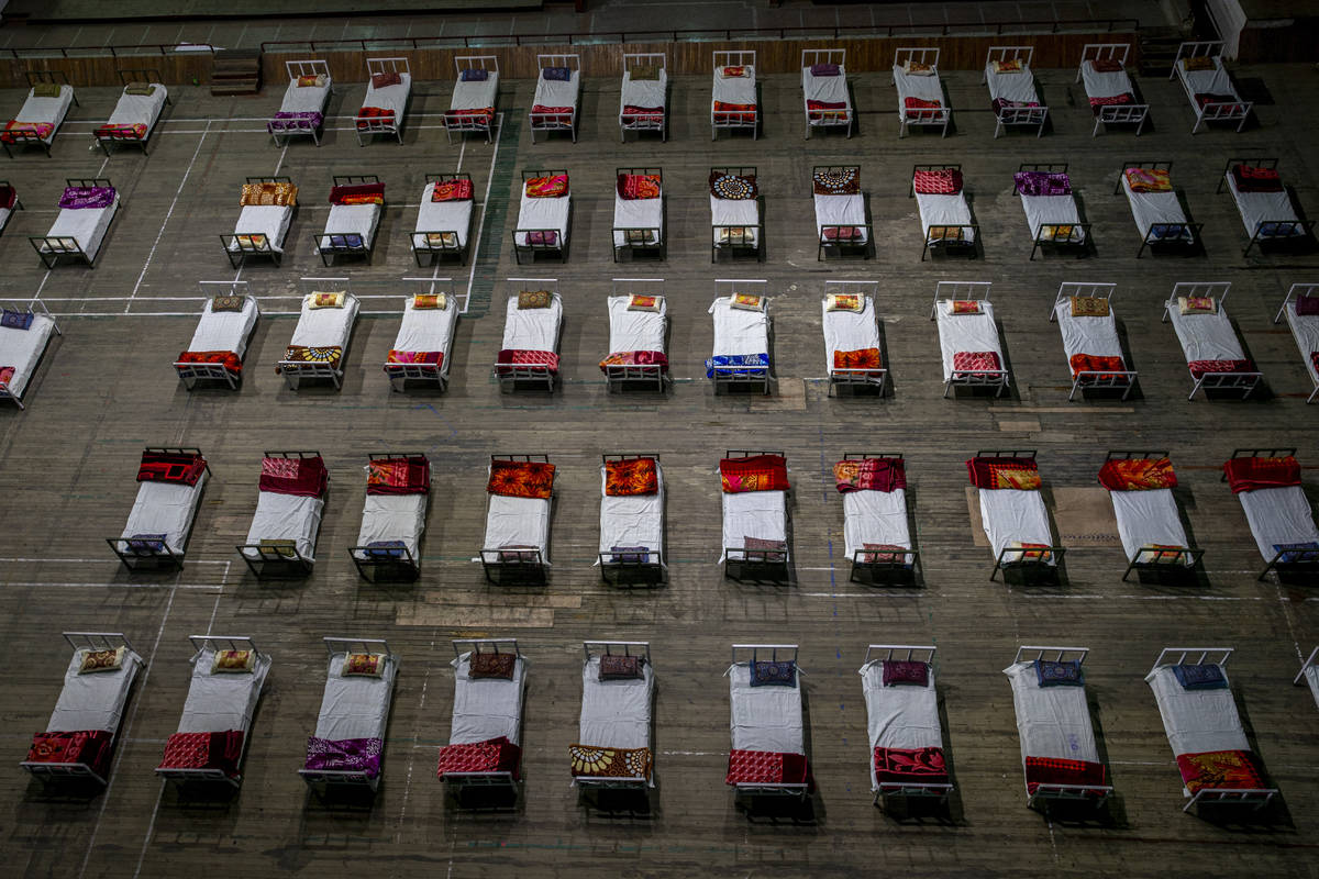 Beds lie inside an indoor stadium converted into COVID-19 treatment center for emergencies in t ...