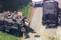 In this image taken from video Wednesday, April 28, 2021, law enforcement work the scene of a f ...