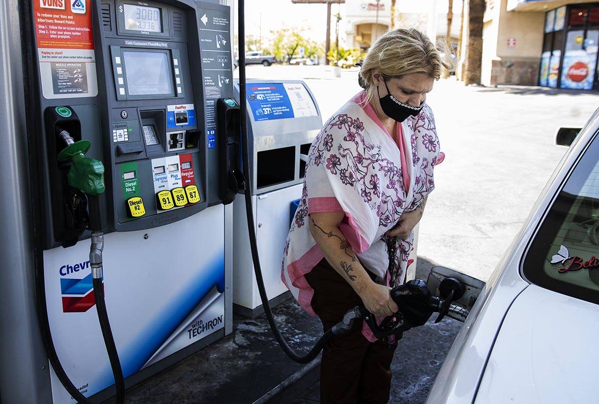 Crystal Tippit of Orange County, Calif., pumps gas at Chevron on Tropicana Avenue, on Wednesday ...