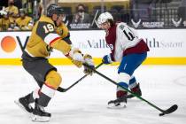 Golden Knights right wing Reilly Smith (19) competes for the puck with Avalanche defenseman Sam ...