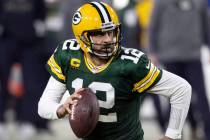 FILE - In this Jan. 16, 2021, file photo, Green Bay Packers quarterback Aaron Rodgers (12) runs ...