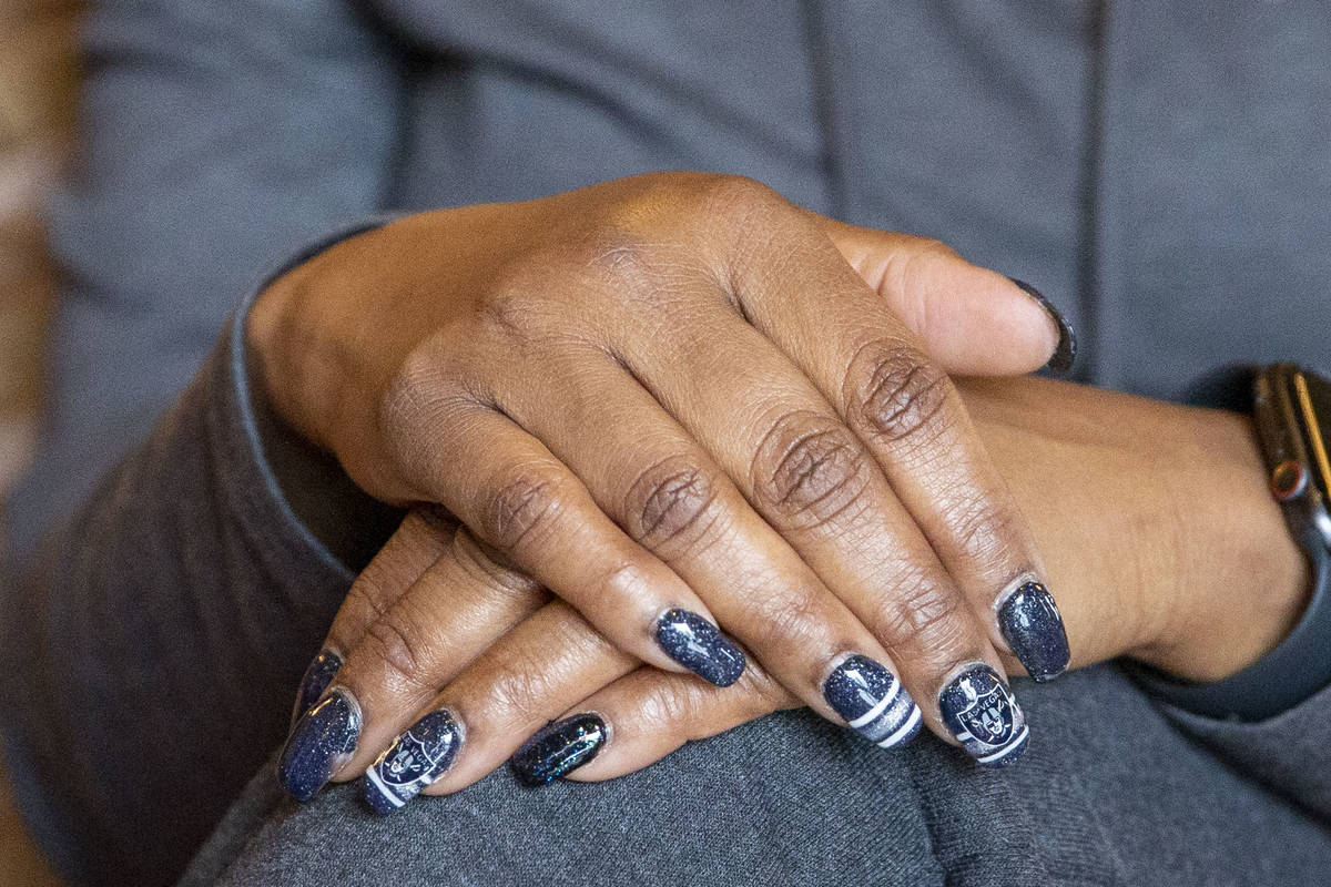 Denean Vaughn, who was selected as the Raiders Fan of the Year, shows off her manicure at the R ...