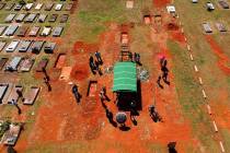 A family attends the burial service for David Ferreira Gomes, who died from complications relat ...