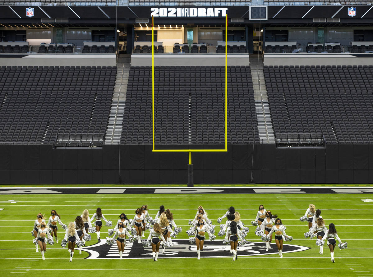 The Raiderettes perform on the field before fans spread throughout the stands during the 2021 L ...