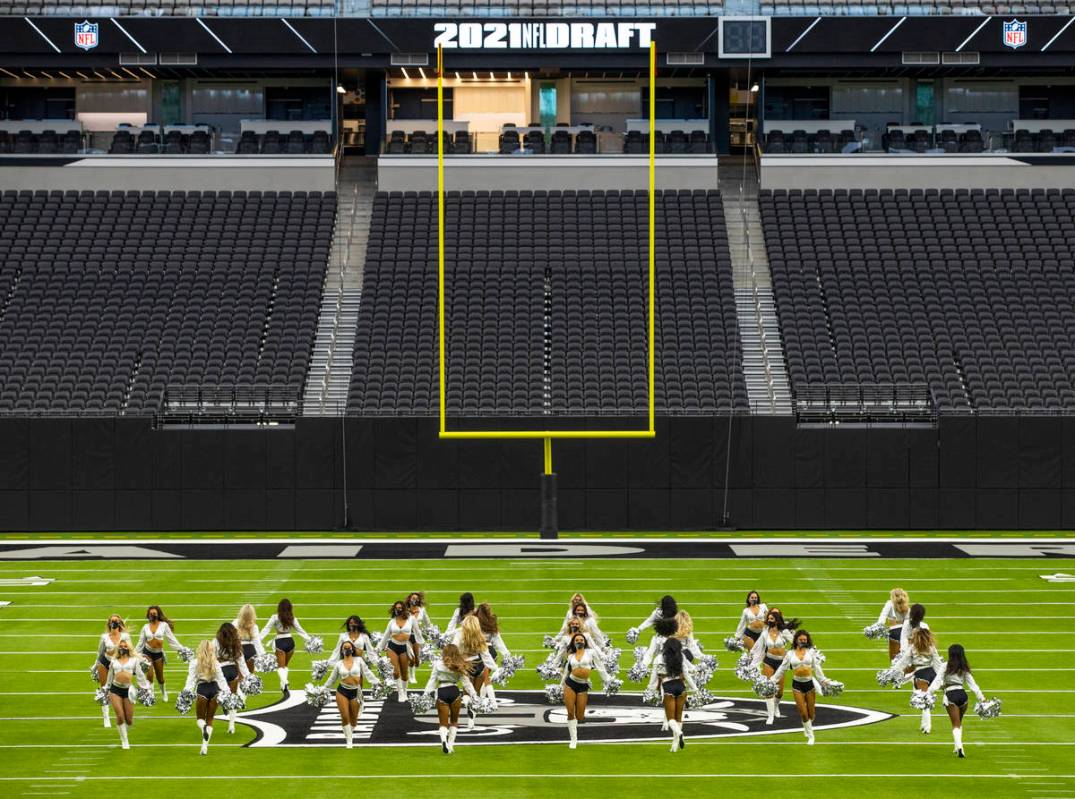 The Raiderettes perform on the field before fans spread throughout the stands during the 2021 L ...