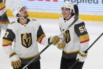 Vegas Golden Knights' Dylan Coghlan (52) smiles with his teammate Shea Theodore (27) after Cogh ...