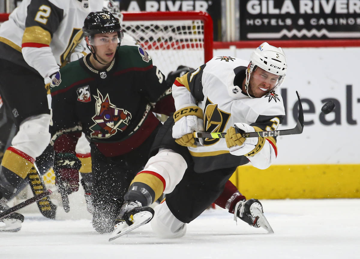 Golden Knights' Brayden McNabb (3) passes the puck in front of Arizona Coyotes' Michael Bunting ...