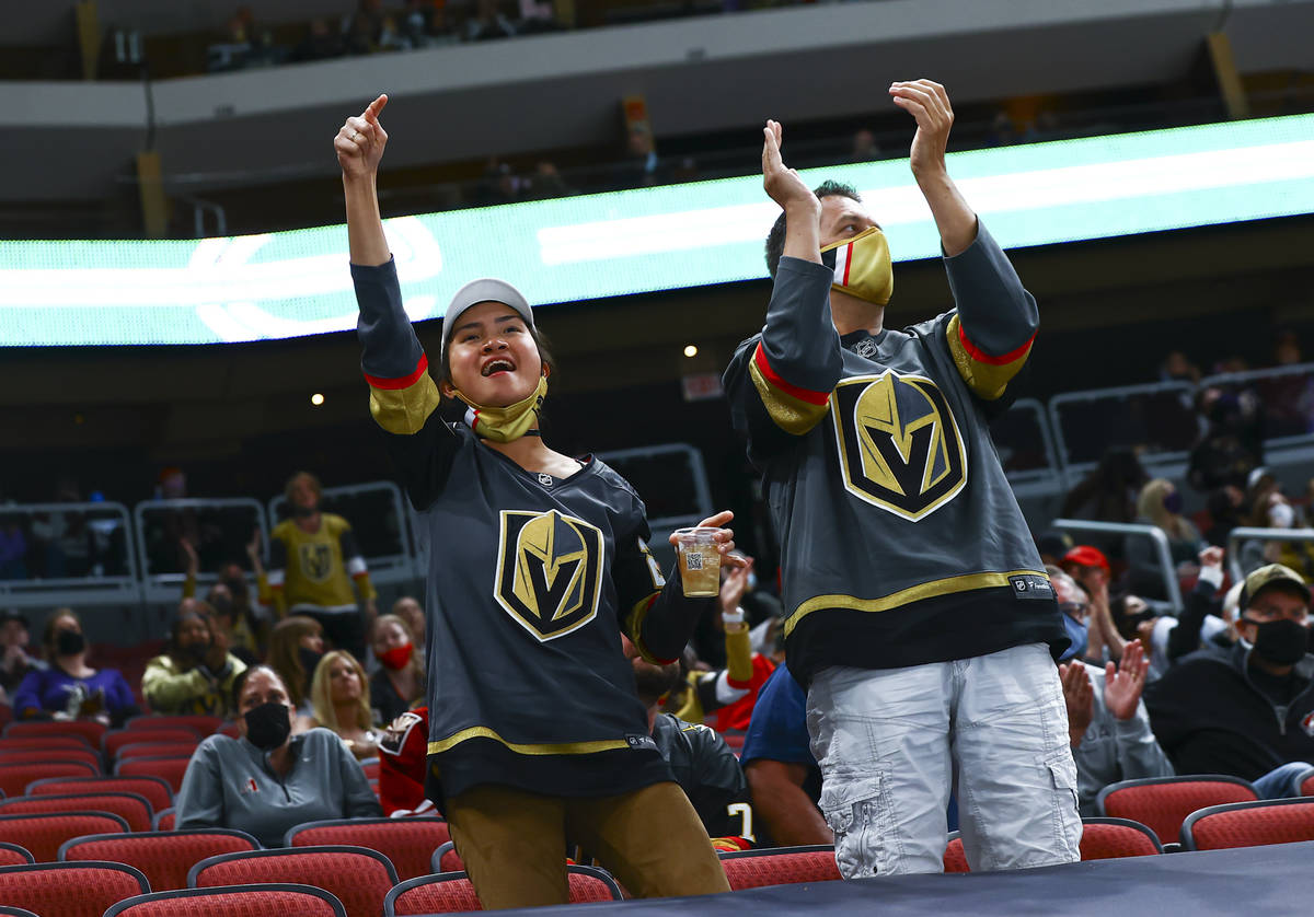 Golden Knights fans cheer during the second period of an NHL hockey game against the Arizona Co ...